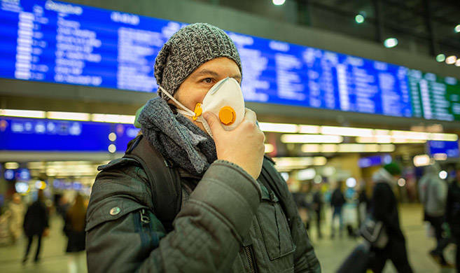 man wearing a mask in an airport