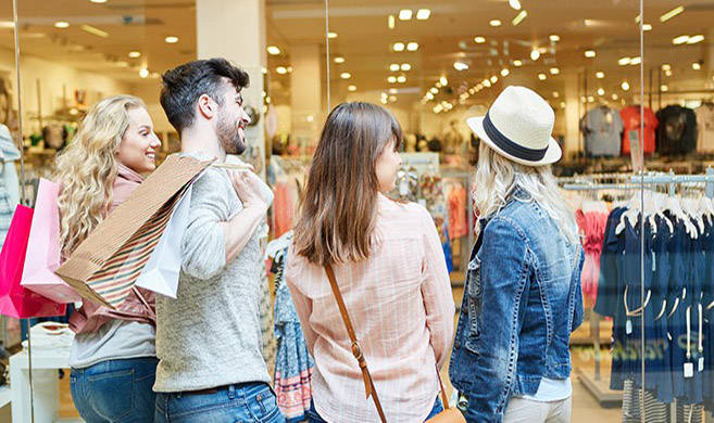 Group of young people shopping and smiling - Robert Kneshcke