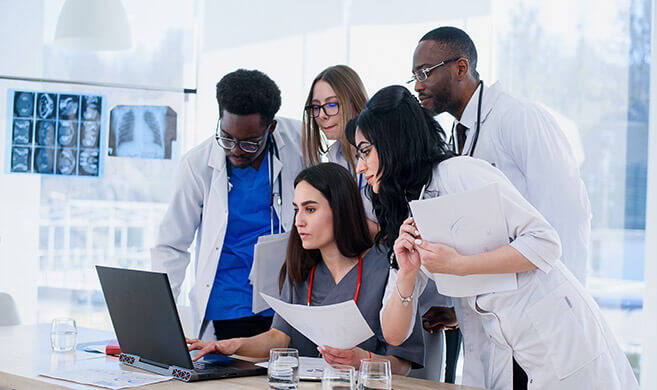 group of people working in white blouses - gorynvd-AdobeStock