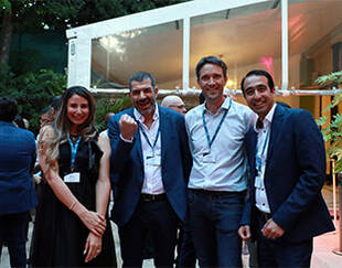 Four professionals, two men and two women, posing for a picture in a professional setting