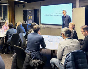 Man standing in front of a group of business professionals