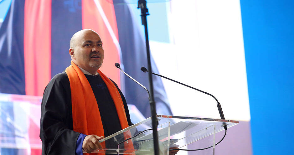 Man standing at a podium, delivering a speech or presentation